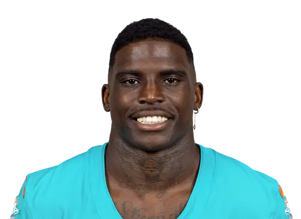 Headshot of Tyreek Hill wearing a Miami Dolphins aqua jersey against a black background