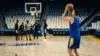 Veteran basketball player preparing to shoot on a blue-and-gold NBA-style court