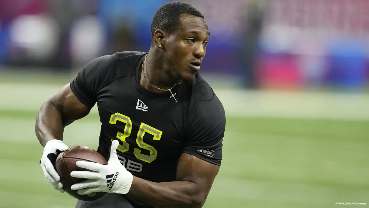 Zamir White wearing a black jersey with number 35 holding a football during an NFL Combine workout