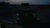 Darkened college football stadium during a power outage with the field faintly lit by emergency lights